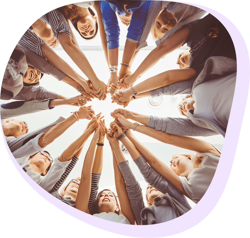 Group of people joining hands in circle