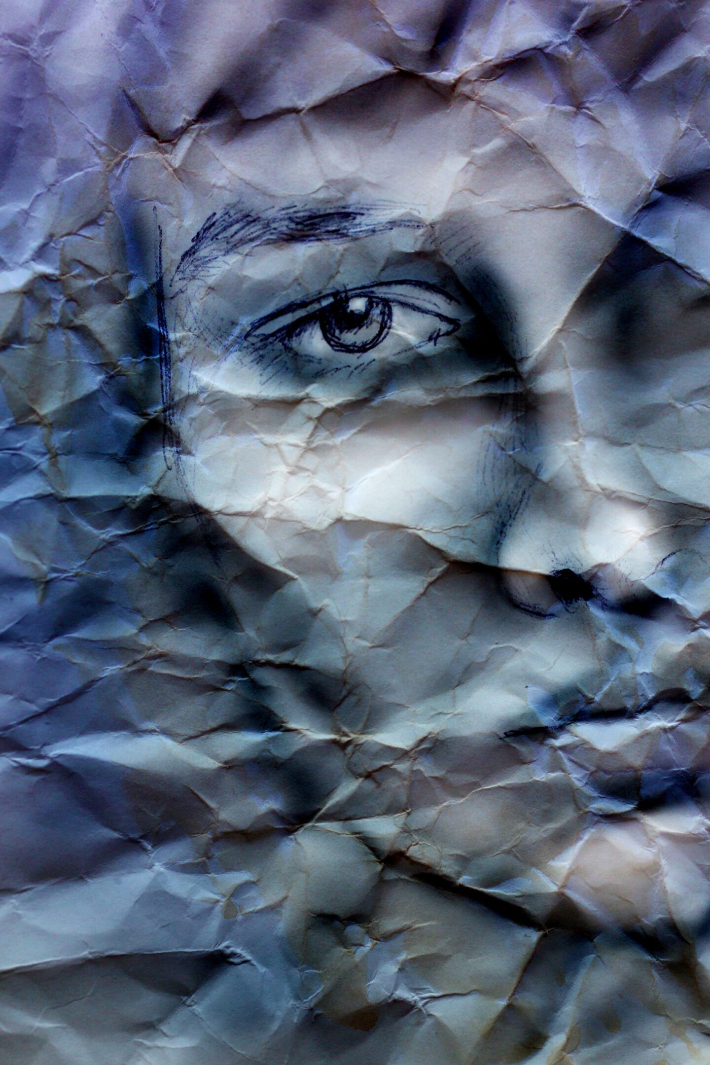 Crumpled paper with sketched face