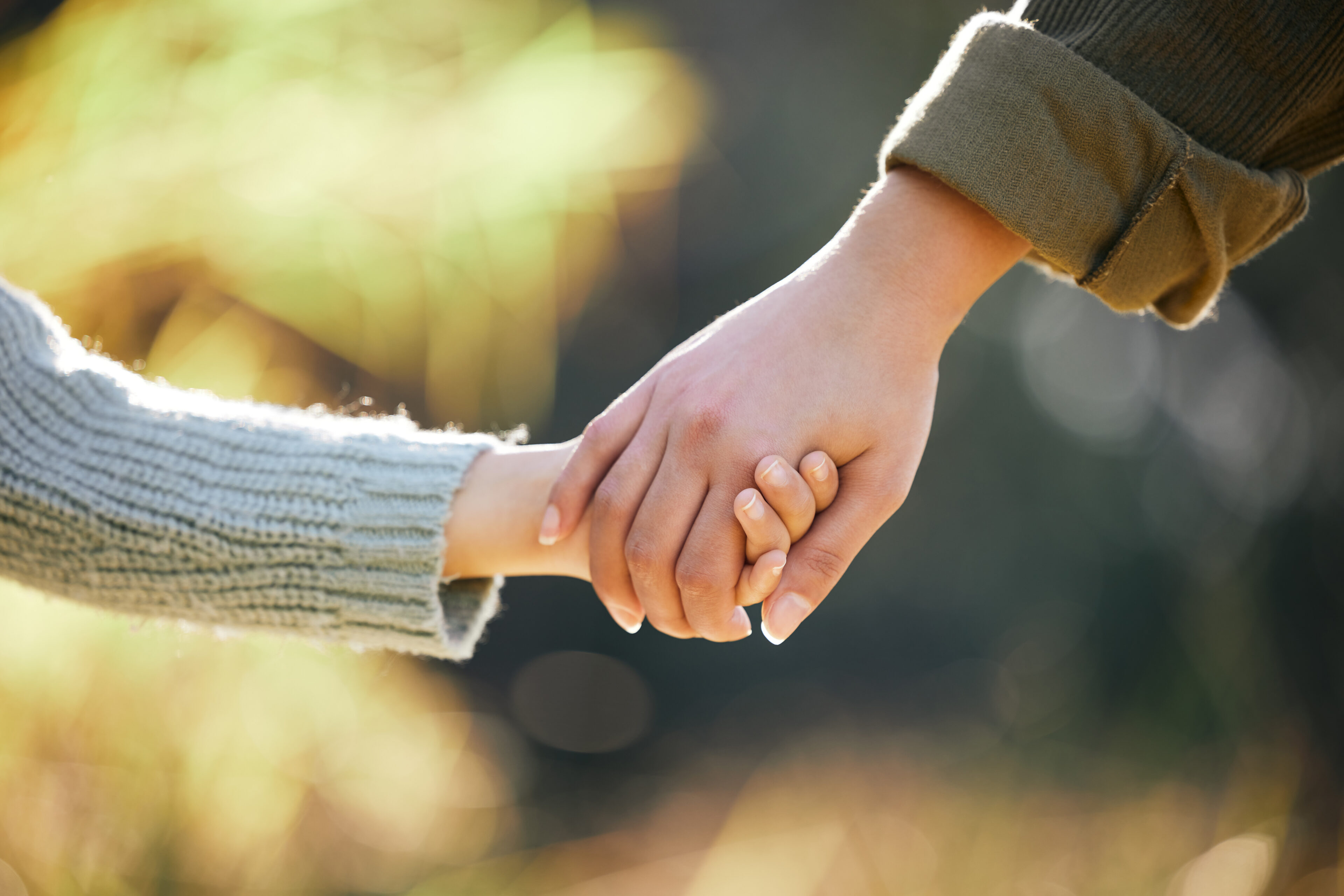 Holding hands, love or mother and child at park for travel, bonding and support in nature together at sunset. Security, safety and mama with kid in forest with hope, help and guidance, trust and care.